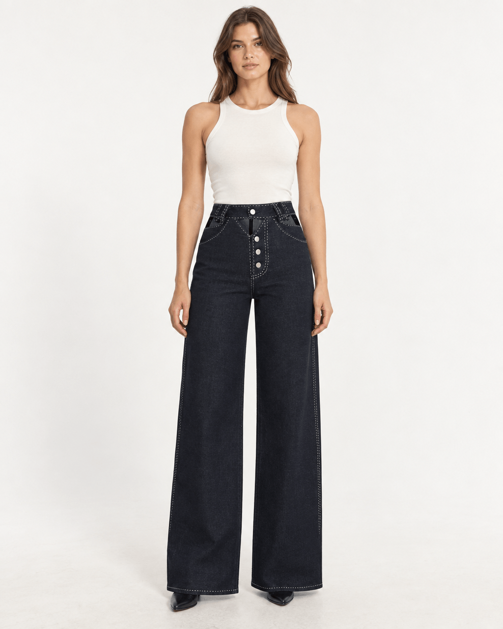 Model wearing JENDUE Livia Trousers - Wide-Leg High-Waist Navy Denim with a white tank top.
