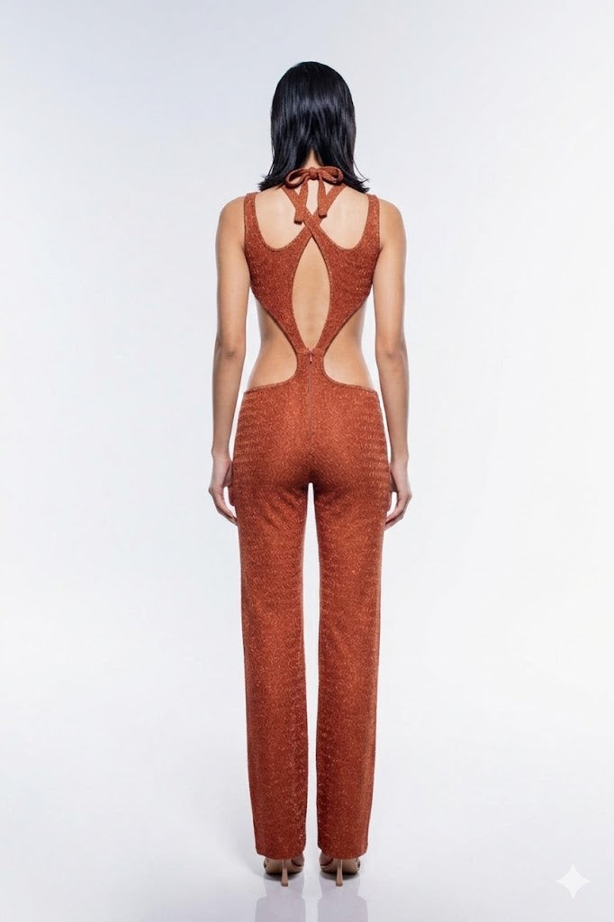 Person wearing a rust-colored jumpsuit with cut-out design on a white background