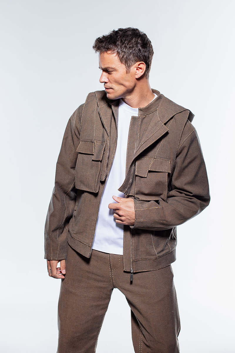 A durable, stylish men's denim jacket in a warm brown shade, complete with a zip-up inner layer and multiple chest pockets.