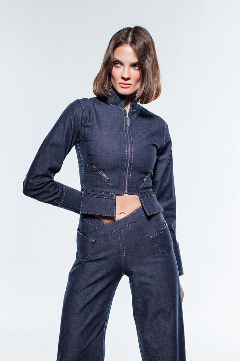 Cropped navy jacket with a structured collar, zippered front, and wide cuffs.