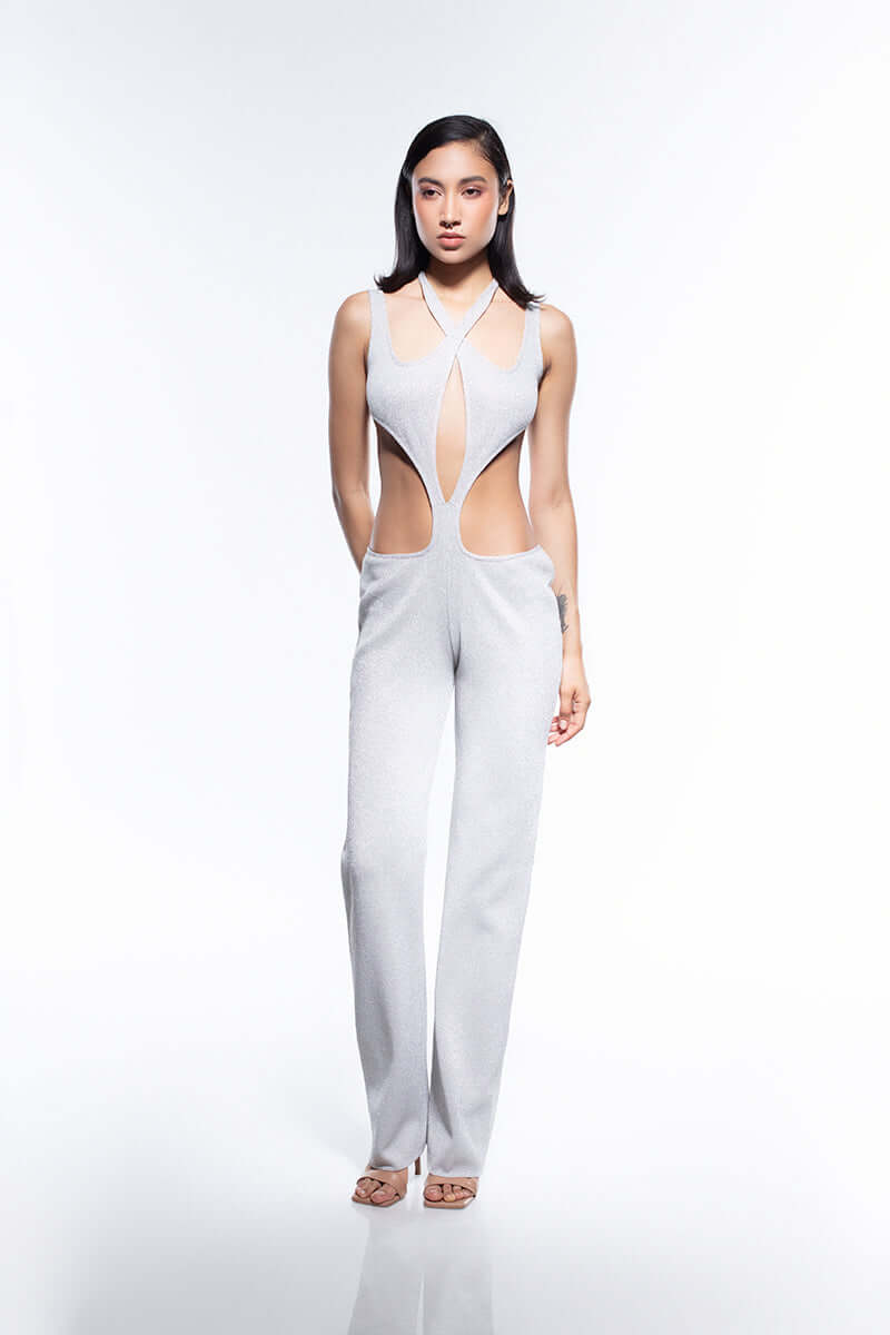 Shiny silver jumpsuit featuring a halter neck and strategic torso cutouts that create a flattering, sculpted silhouette.