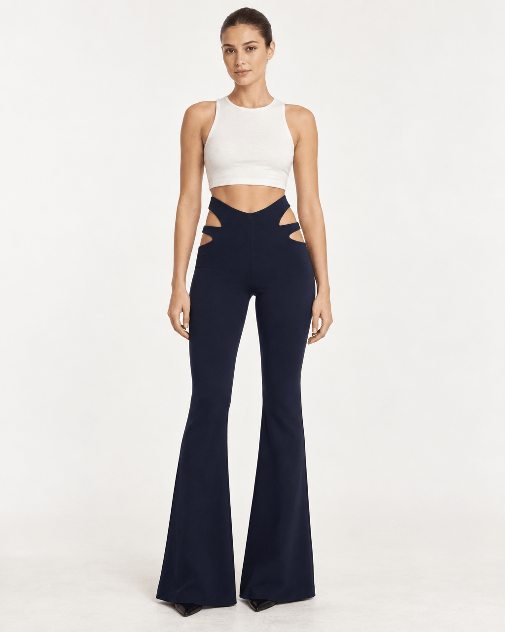 JENDUE Luma Eria Trousers - Cut-Out High-Waist Flare Pants worn by model, featuring stylish side cut-outs and a flattering fit.
