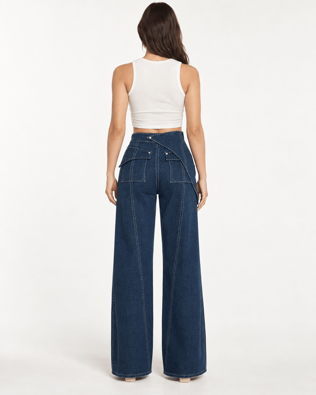 Back view of a woman wearing JENDUE Liora Trousers - High-Waist Wide-Leg Denim Pants, showcasing their stylish design.