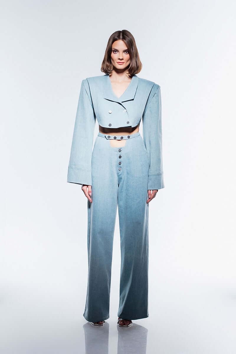 JENDUE Stormbringer ice blue wide-leg jeans with a high waist and a unique exposed button-fly closure. The jeans feature prominent stitching details and a tailored fit, all on a white background.