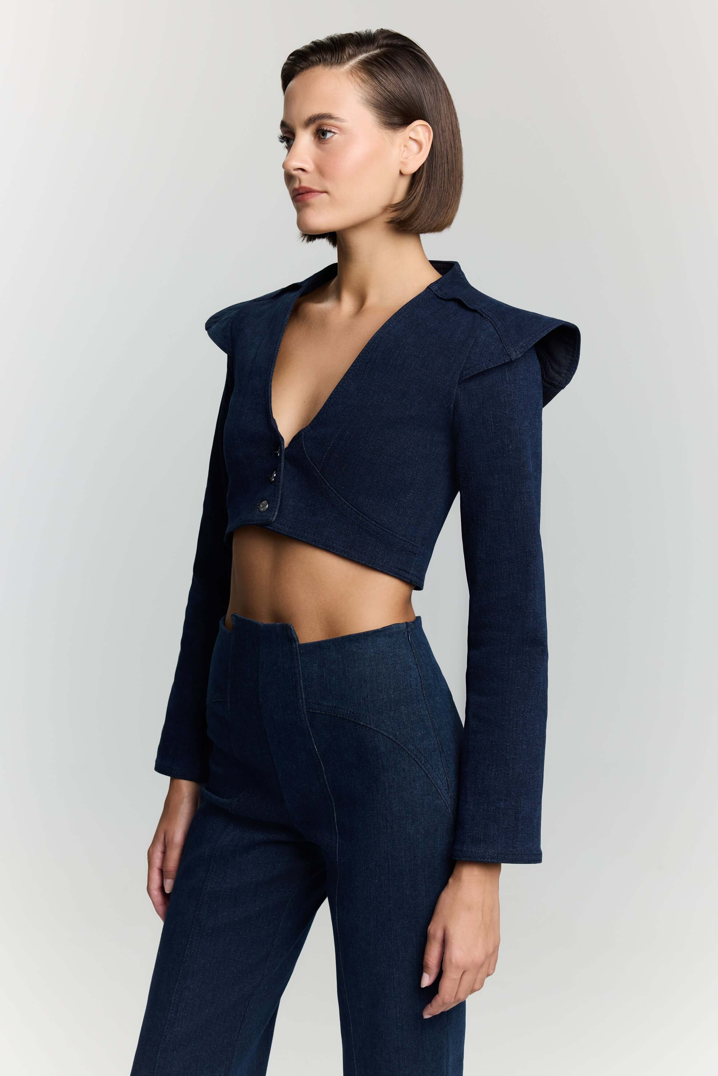 JENDUE Dark blue denim short jacket by JENDUE, featuring long sleeves and a sophisticated design.