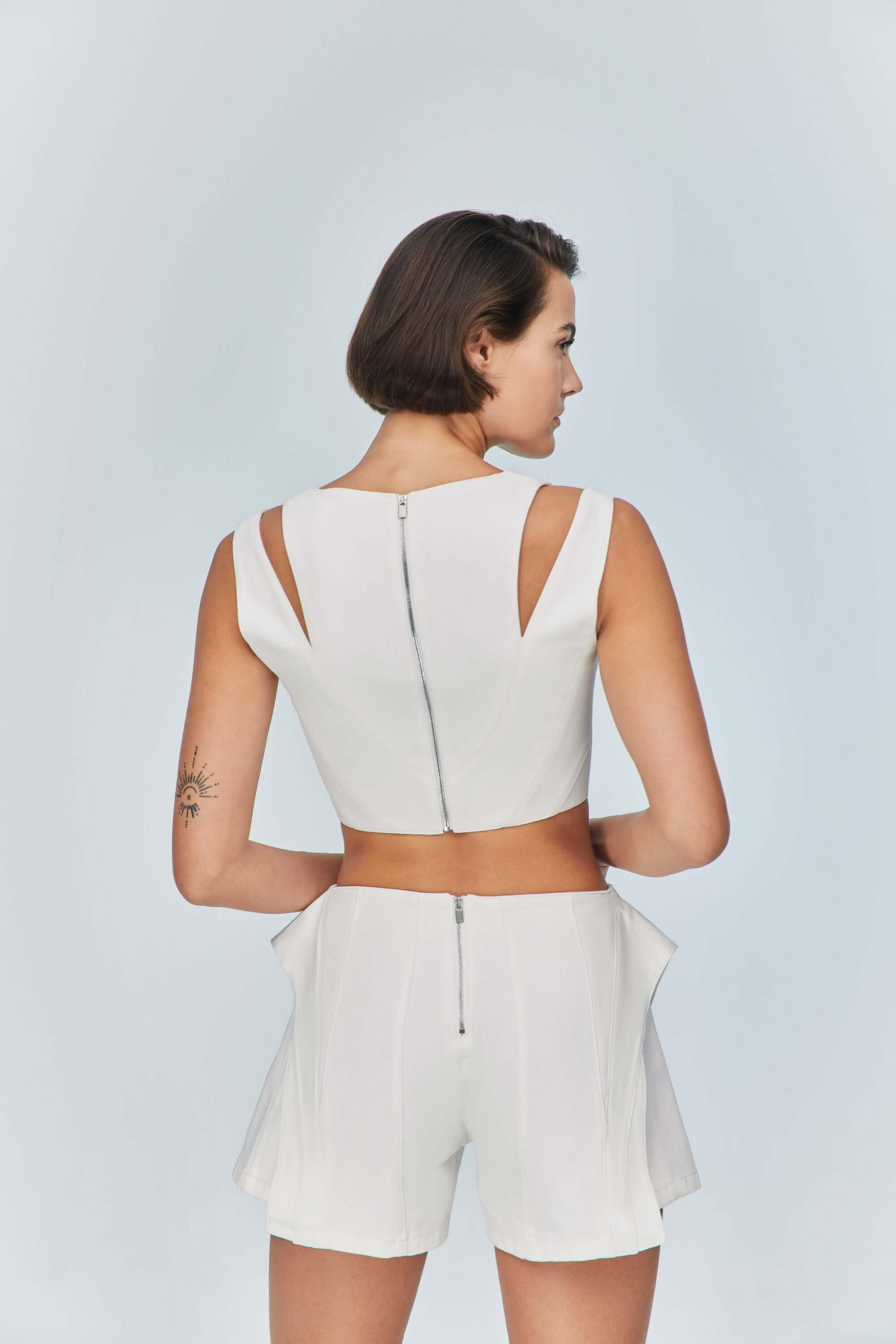 JENDUE trendy white denim shorts, perfect for a statement, with its asymmetrical wrap-around detail.