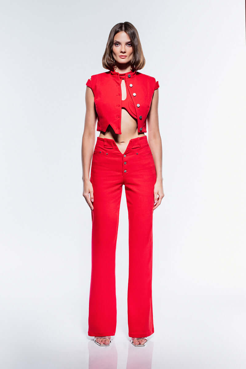 A vibrant red denim crop top with an asymmetrical, button-down front and a high collar.