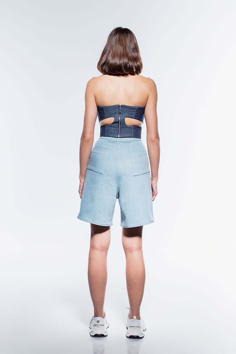 Strapless, navy blue denim bustier top featuring white stitching detail and a form-fitting silhouette.