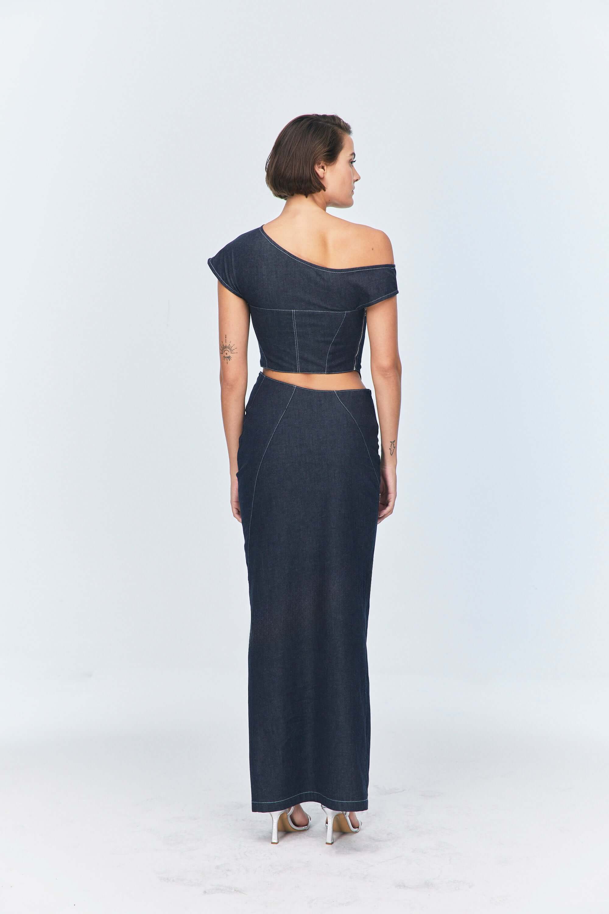 JENDUE modern dark blue denim midi skirt, designed with an overlap and a bold front opening.