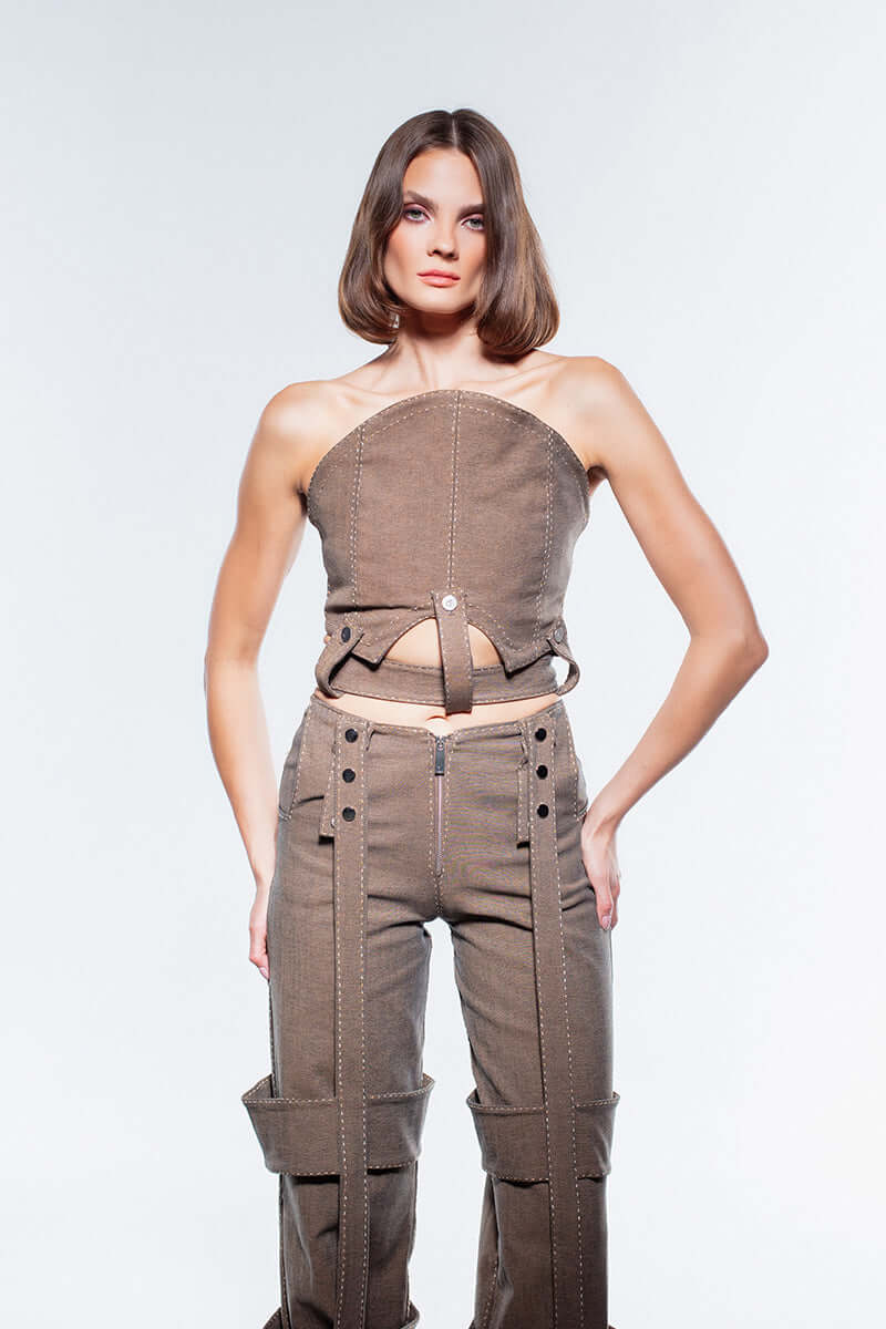 JENDUE Wild Flower Denim Corset Top in brown. Features visible white stitching, an angled hem, and two side buckles.